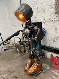a robot sitting on a table in a workshop